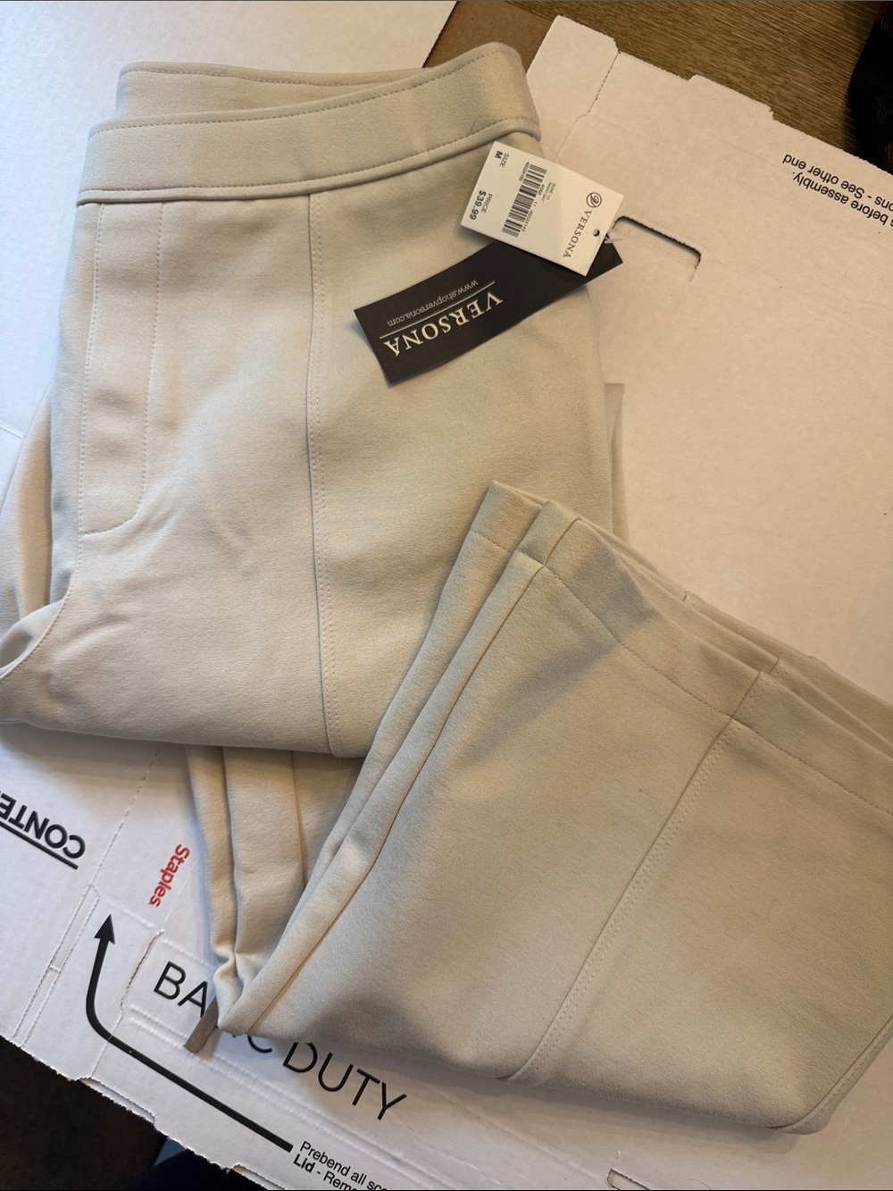 New with tagsWomen’s VersonaCream/Tan pants size medium- boot leg stretch pants